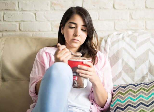 Sad woman eating ice cream