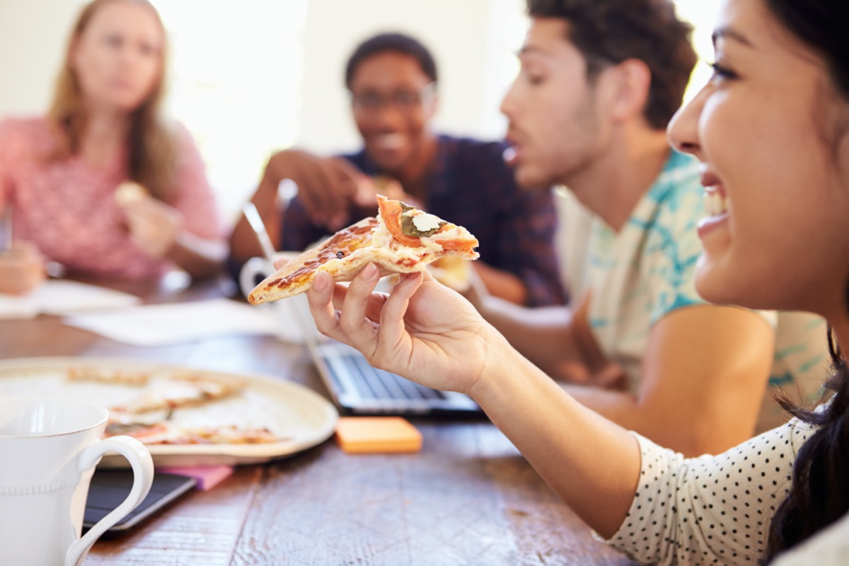 Business People Having Meeting And Eating Pizza