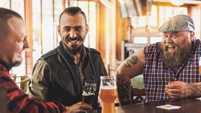 Men and guys out drinking beer at a bar