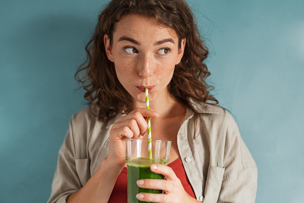 woman drinking an organic green smoothie