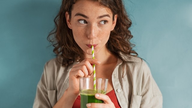 woman drinking an organic green smoothie