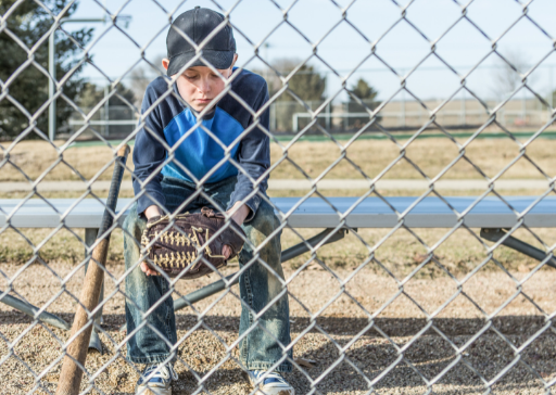 young boy sitting on bench signs of abandonment issues