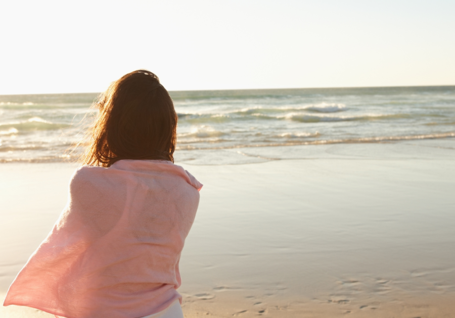 woman being serene watching the sea waves how to let things go in a relationship 