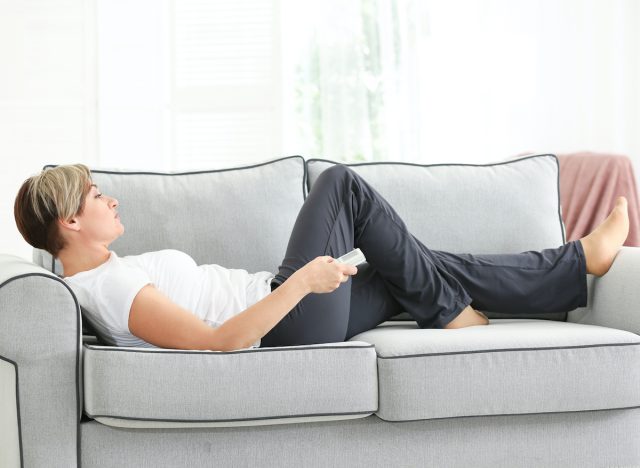 woman on couch sedentary lifestyle concept