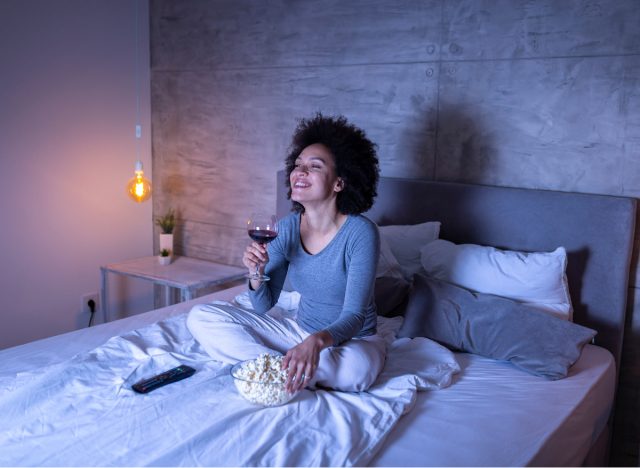 woman snacking in bed