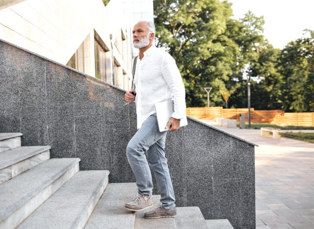 fit senior man taking stairs, habits to slow down muscle aging