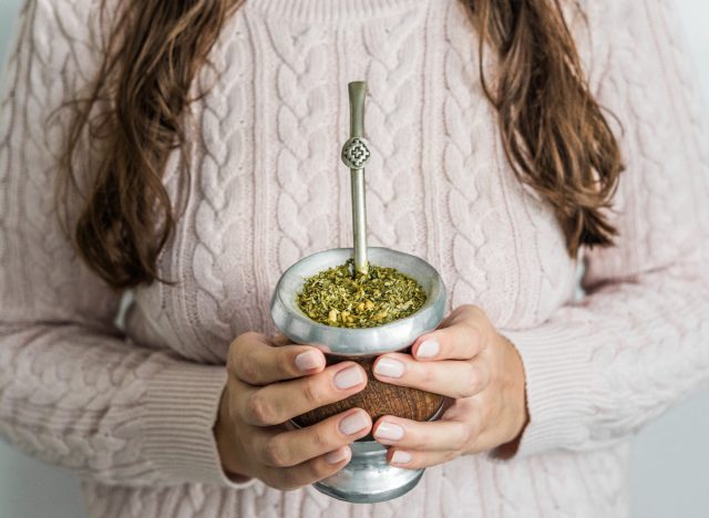 woman holding yerba mate tea