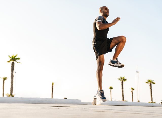 fit man doing standing cardio workout jumps