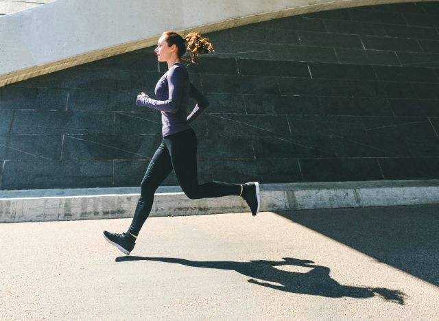 woman sprinting outdoors, concept of best exercises to lose weight