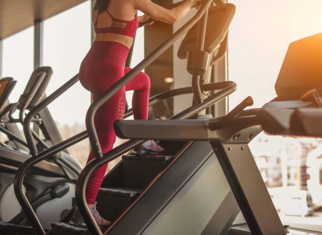 woman using stairmaster machine at the gym