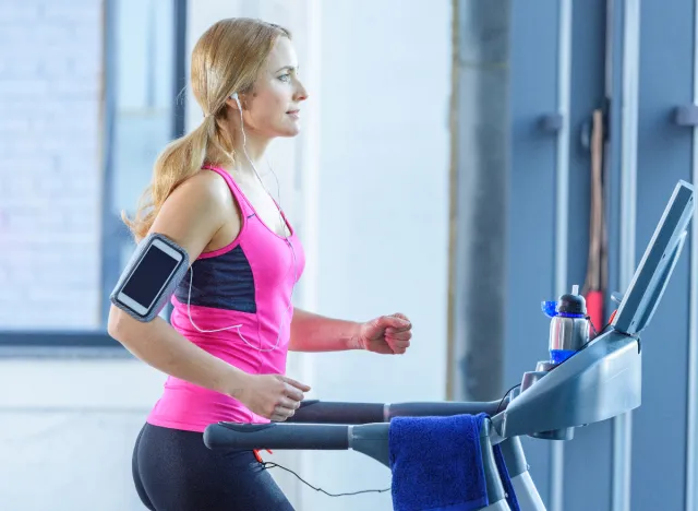 fit blonde woman doing treadmill incline walking workout