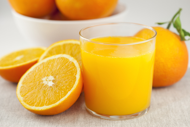 Sliced and Whole Oranges with Glass of Orange Juice | Foods that help with muscle cramps