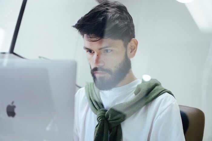 man at desk working on Mac find a job you love