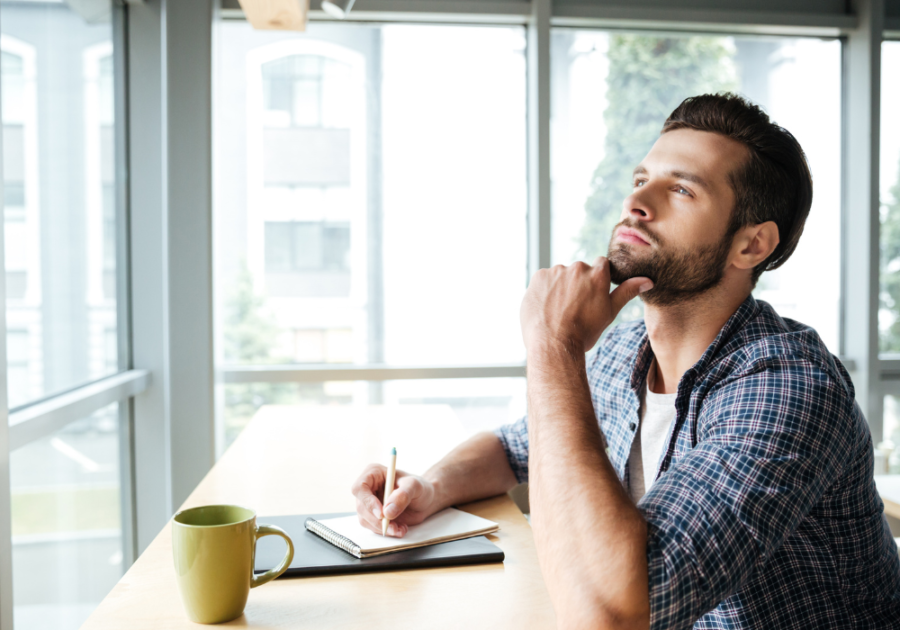 man thinking and writing how to calm your anger