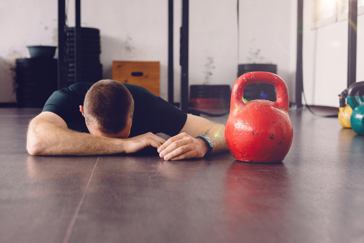 Athlete Exhausted Next to Kettlebell | keto bodybuilding