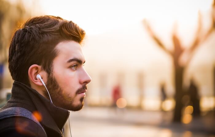 man listening to music in headphones how to calm down