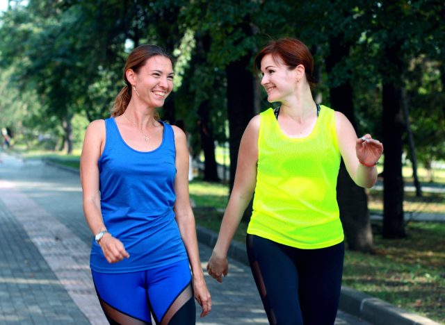 two female friends walking outdoors