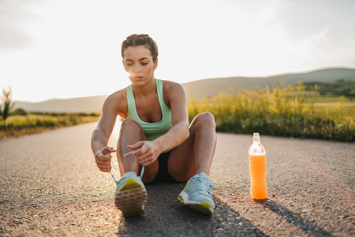 Athlete Tying Shoes with Sports Drink | Stim Free Pre-Workout