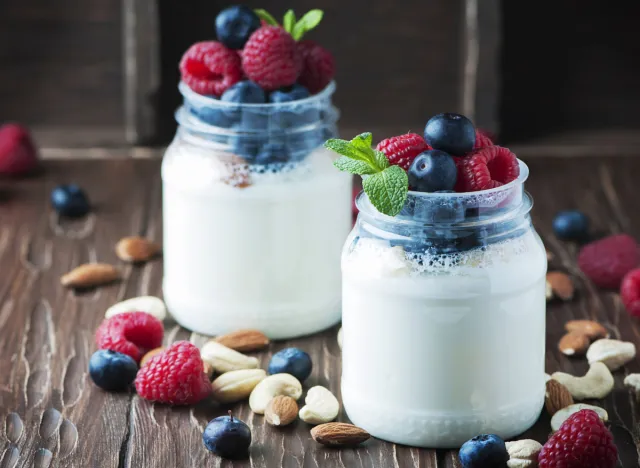 Greek yogurt parfait in mason jars with blueberries and raspberries and nuts