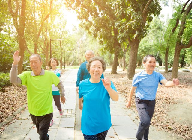 a group of people walking in a park and smiling