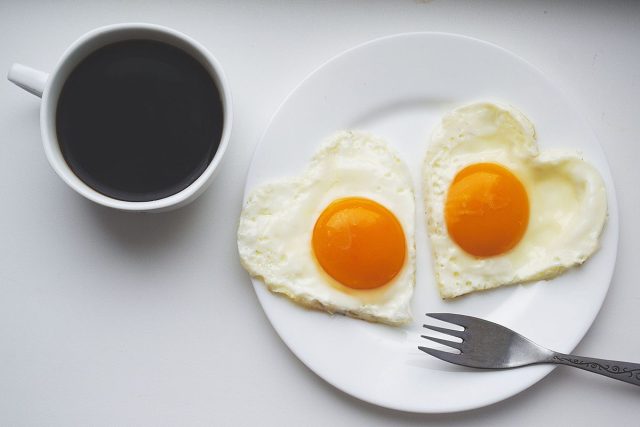 Cup of black coffee and eggs