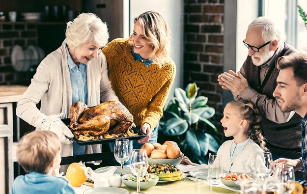 A family getting ready to eat their Thanksgiving meal.